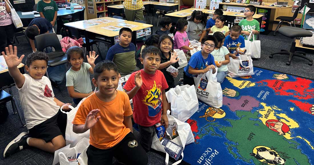 children waving at the camera